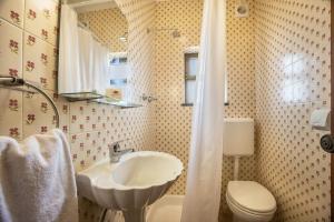 a bathroom with a sink and a toilet at Cabo de Sagres -2 bedroom apartment in Sagres +20 photos