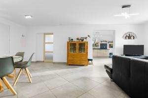 a living room with a couch and a table and chairs at Maison Saint-Raphael - Les Vignes in Saint-Raphaël