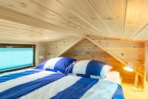 a bedroom with a bed in a wooden room at Tiny House Evita in Lehnin