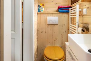 a bathroom with a wooden toilet and a sink at Tiny House Evita in Lehnin +17 photos