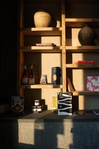 a book shelf with books and other items on it at Otonali hôtel by Breizh Café in Saint Malo