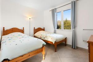 a bedroom with two beds and a window at Maison Saint-Raphael - Les Vignes in Saint-Raphaël +30 photos
