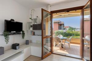 a living room with a sliding glass door and a balcony at Casa Vacanze da Ricky App 5 in Peschiera del Garda