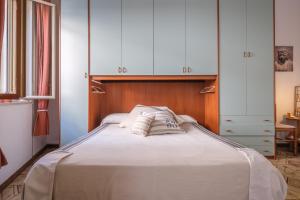 a bedroom with a bed with two pillows on it at Tyndaris home in Oliveri