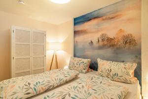 a bedroom with a bed and a painting on the wall at Schwarzwald Wölkchen in Baiersbronn +28 photos