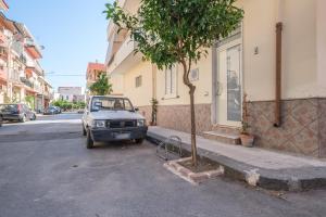 a small car parked on the side of a street at Tyndaris home in Oliveri
