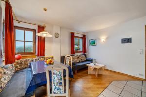 a living room with a couch and a table at Rieglhof Apartment Maisel in Curon Venosta