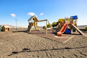 a playground with a slide in the sand at Duplex vista mar in Yaiza