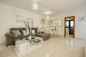 a living room with a couch and a table at Duplex vista mar in Yaiza