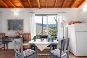 a dining room with a table and a window at Casa Claudia in Hermigua +18 photos