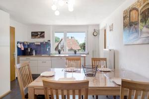 a kitchen and dining room with a table and chairs at Bauernhofwohnung Friedrichshafen in Friedrichshafen