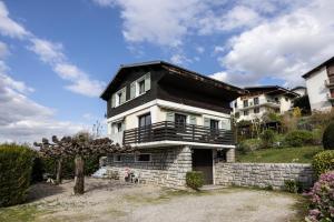 a house with a black and white at Chalet Les Tourelles in Aix-les-Bains