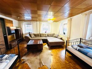 a living room with a couch and a table at Bauernhofwohnung Friedrichshafen in Friedrichshafen