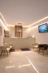 a lobby with a bar with chairs and a counter at Rabie Aparthotel in Prague