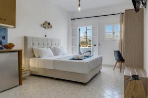 a bedroom with a large white bed in a room at Seaview Double Room Private Jacuzzi in Santorini