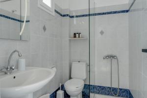 a bathroom with a toilet and a sink and a shower at Seaview Double Room Private Jacuzzi in Santorini
