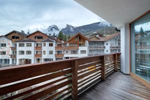 a balcony with a view of a city at Ciasa Irene Dreizimmerwohnung in La Villa