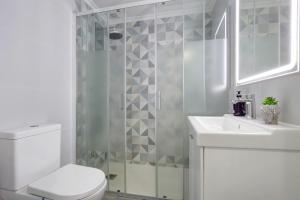 a bathroom with a shower and a toilet and a sink at Apartamento 7 dioses in Puerto del Rosario +20 photos