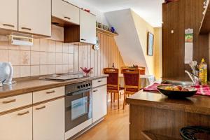 a kitchen with a sink and a stove top oven at Reichenaublick in Allensbach