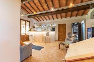 a living room with a kitchen and a bar at Masseria del bosco Poderuccio in Chianciano Terme