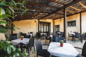 an outdoor patio with tables and chairs and awnings at Masseria del bosco Poderuccio in Chianciano Terme