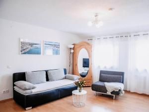 a living room with a couch and a chair at Auszeit am See in Moos