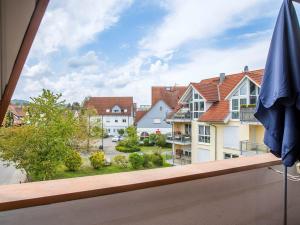 a view from a balcony with a blue umbrella at Auszeit am See in Moos