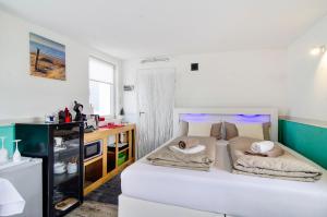 a bedroom with a bed with two pillows on it at Spawo mit Sauna und Whirpool in Pfullendorf