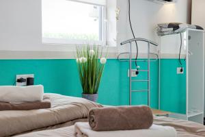 a room with two beds and a green wall at Spawo mit Sauna und Whirpool in Pfullendorf