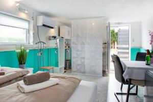 a room with two beds and a table and a desk at Spawo mit Sauna und Whirpool in Pfullendorf