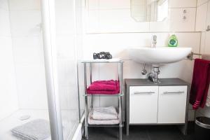 a bathroom with a sink and a toilet and a mirror at Auszeit am See in Moos +12 photos