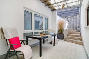 a patio with a table and chairs and stairs at Spawo mit Sauna und Whirpool in Pfullendorf