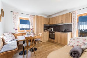 a kitchen and living room with a couch and a table at Ferienwohnung Amethyst in Mittenwald