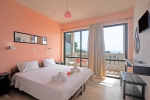 a bedroom with a bed and a large window at Andromaches sea view studio 2 in Corfu