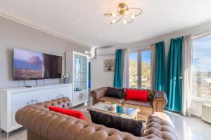 a living room with couches and a flat screen tv at Villa Sol y Mar in Calpe