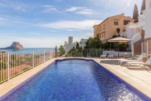 a swimming pool with a view of the ocean at Villa Sol y Mar in Calpe