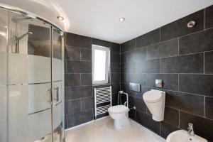 a bathroom with a toilet and a glass shower at Paradies Ligurien - Imperia in Torre Paponi +18 photos