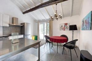 a kitchen with a red table and black chairs at Paradies Ligurien - Imperia in Torre Paponi