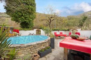 a pool in a yard with a table and chairs at Paradies Ligurien - Imperia in Torre Paponi