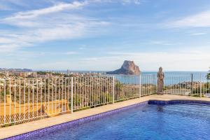 a villa with a pool and a view of the ocean at Villa Sol y Mar in Calpe