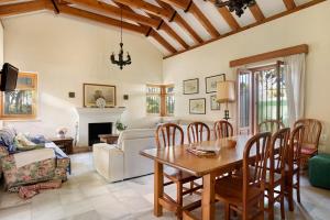 a living room with a wooden table and chairs at El Mirlito in Roche