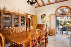 a dining room with a wooden table and chairs at El Mirlito in Roche +17 photos