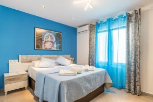 a blue bedroom with a bed with blue walls at Villa Sol y Mar in Calpe +25 photos