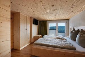a bedroom with a bed with a wooden ceiling at Ferienhaus Fenzl in Johanngeorgenstadt