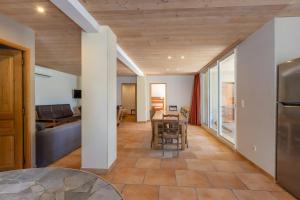 a living room with a table and a couch at Le Serre Du Puech in Chambonas