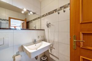 a bathroom with a sink and a mirror at Oewern Diek in Wustrow +16 photos