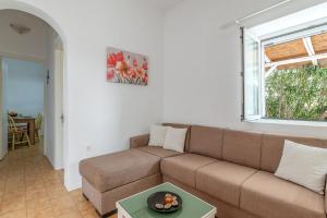a living room with a couch and a table at Margaret House in Parikia
