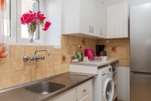 a kitchen with a sink and a refrigerator at Margaret House in Parikia +17 photos
