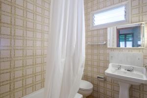 a bathroom with a white shower curtain and a sink at Apartamento las Palmeras 2 in Benicarló +16 photos