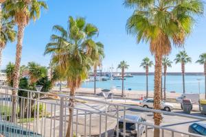 a view of a beach with palm trees at Apartamento las Palmeras 2 in Benicarló